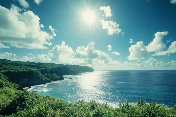 blue ocean and green mountain beach with sun in the blue sky in the Northern Mariana Islands