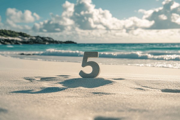 The number 5 on a beach