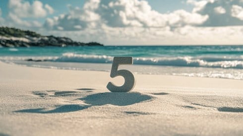The number 5 on a beach