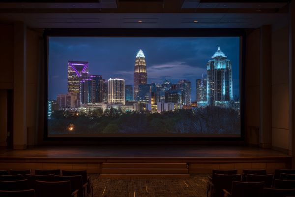 skyline of Charlotte, North Carolina projected onto a screen in a hotel auditorium