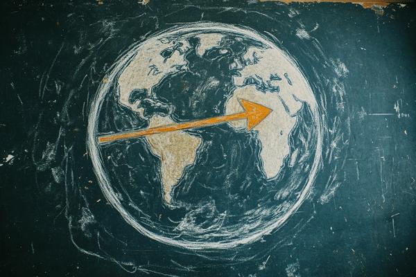 A drawing of the Earth with an orange arrow going across the equator