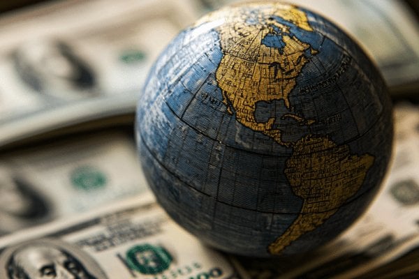A globe on a pile of money