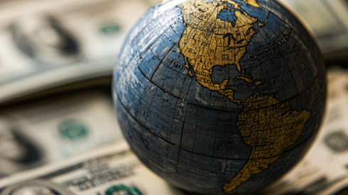 A globe on a pile of money
