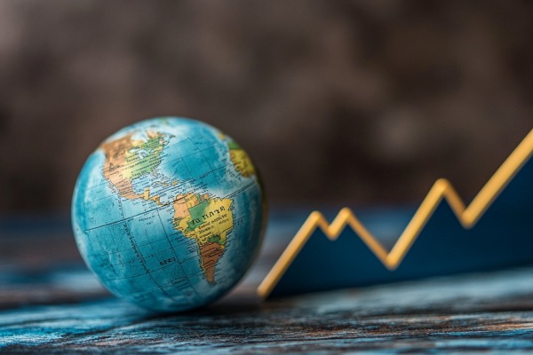 A globe next to a line graph that is trending upward