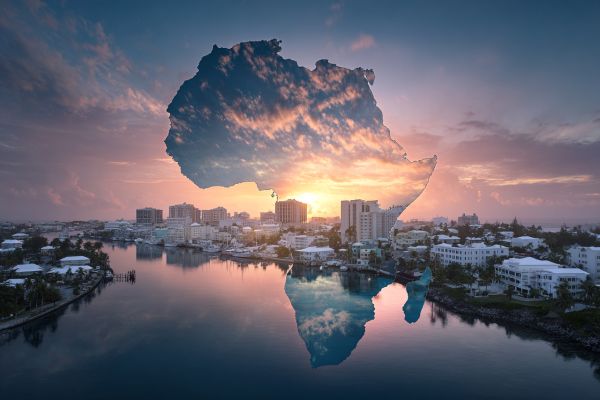 sunrise in the harbor of Hamilton, Bermuda with a transparent Africa overlaid on top