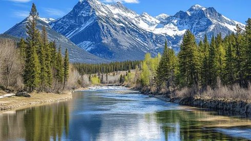 A river in front of snow-capped mountains in the springtime
