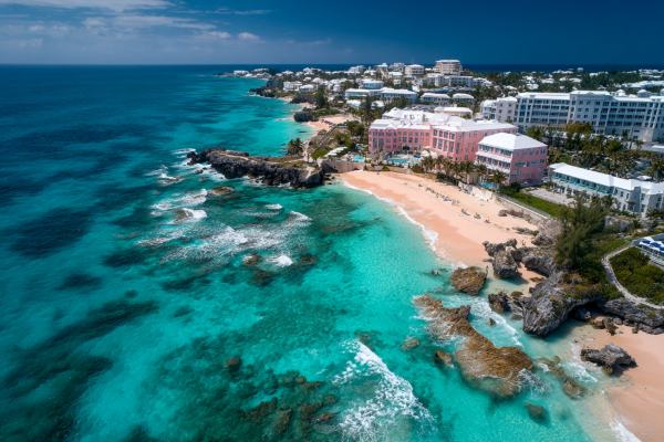 overhead drone view of a Bermuda beach and water near a hotel district
