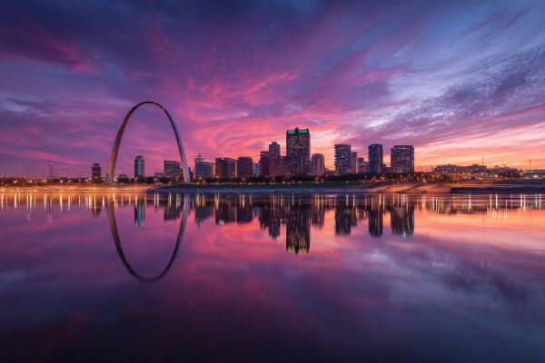St Louis Missouri skyline at dusk with the arch and buildings reflected in the river
