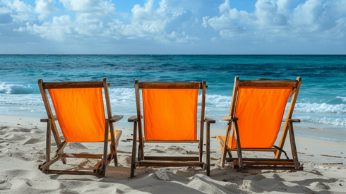 Three orange canvas beach chairs sitting on a beach next to each other