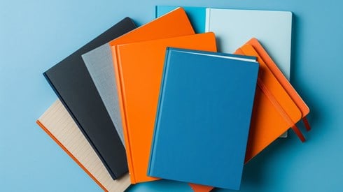 An array of notebooks in various colors