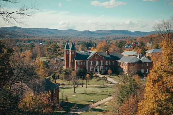 collegiate campus buildings in Arkansas with the Ozark mountains in the background