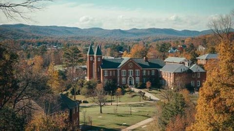 collegiate campus buildings in Arkansas with the Ozark mountains in the background