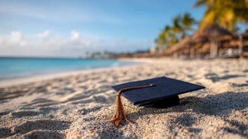 graduation cap on a Cayman Islands beach