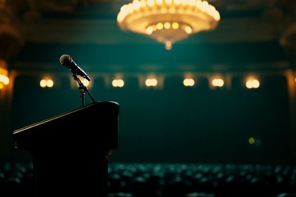microphone on a podium in an auditorium with a large chandelier