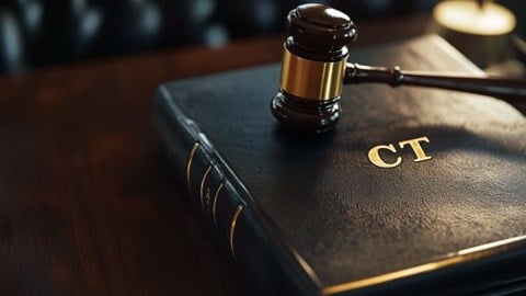 leather binder with the letters "CT" stamped on front with a gavel resting on top