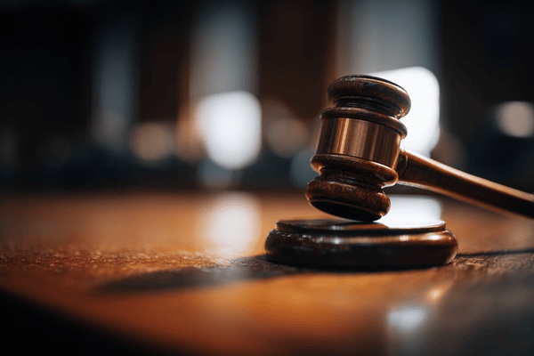 A closeup of a wooden gavel in a cortroom