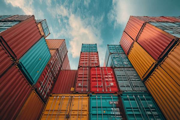 Lots of shipping containers stacked up high