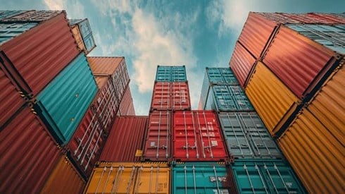 Lots of shipping containers stacked up high