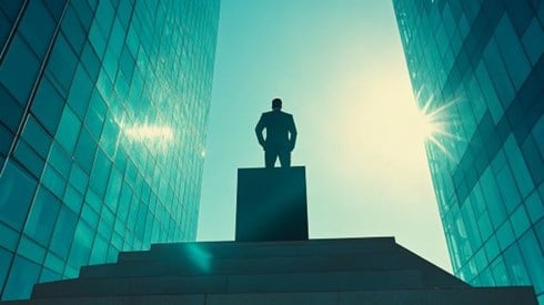 businessman on top of a podium surrounded by glass offices
