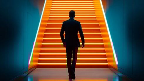 businessman walking up orange stairs