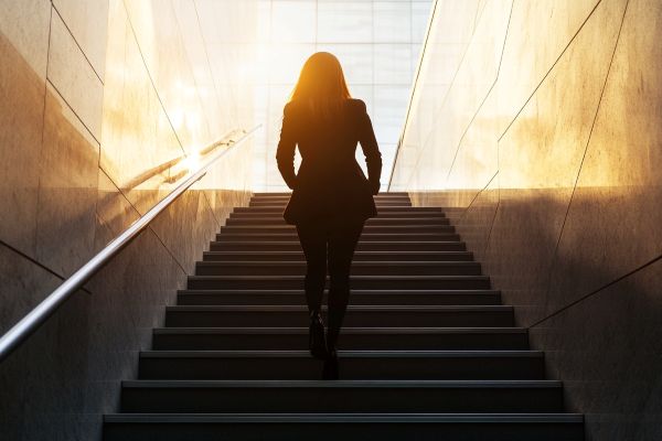 businesswoman silhouette climbing stairs