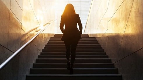 businesswoman silhouette climbing stairs