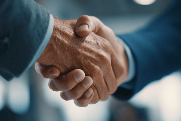 A closeup of a handshake between two businessmen