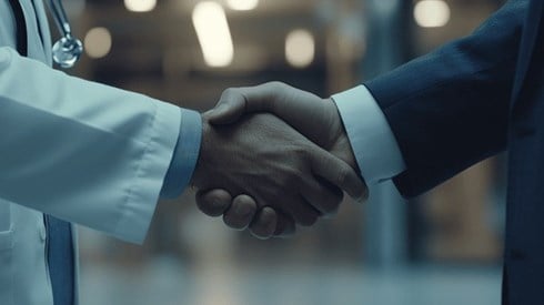 A doctor and a businessman shaking hands