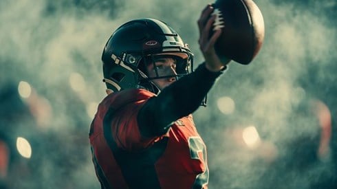 quarterback holding a football in the air
