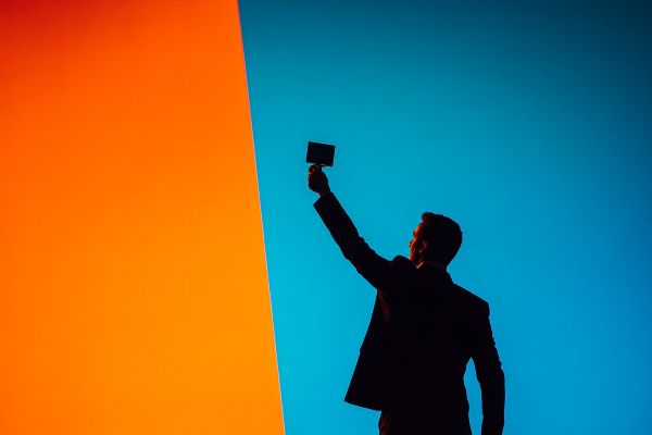 silhouette of a businessman holding up an award