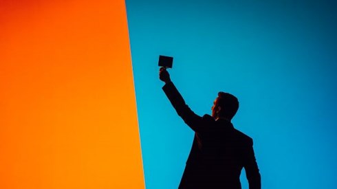 silhouette of a businessman holding up an award