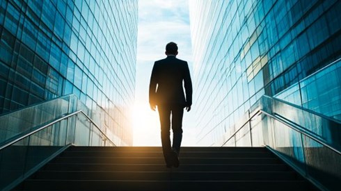 silhouette of a businessman walking up stairs
