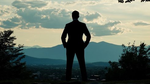 silhouette of a businessperson standing in front of the Vermont mountains