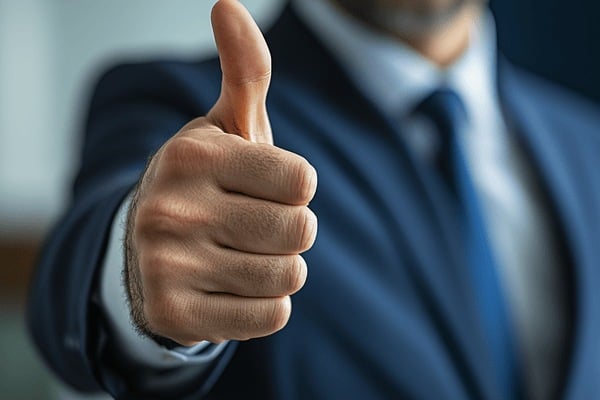A businessman making a thumbs-up