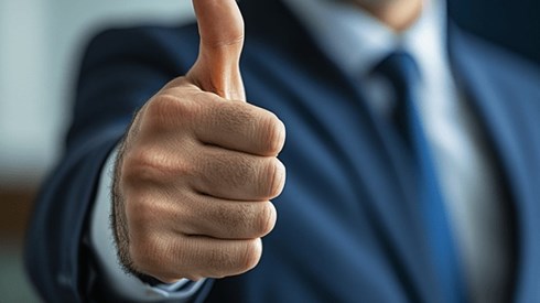 A businessman making a thumbs-up