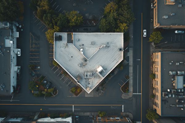 overhead view of a commercial area with a building shaped like a down arrow