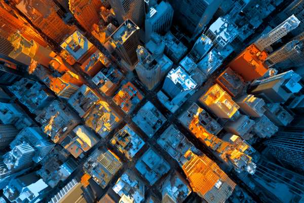 overhead view of a large urban city with blues and oranges overlaid on different blocks