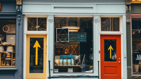 A storefront with two yellow arrows on the doors pointing up
