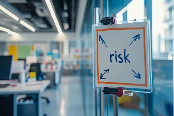small whiteboard with the word "risk" and arrows in a professional office