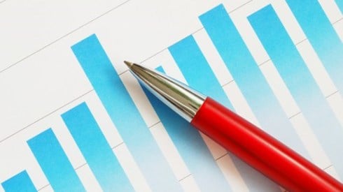 Red pen laying on a blue bar graph printed on a piece of white paper