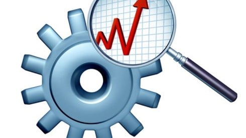 A magnifying glass analyzes two cogs of a gear and reveals a red graph line with high and low markers ending in upward arrow
