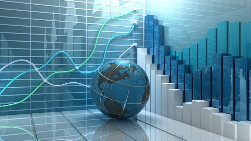 A globe resting on the ground with graphs in the background