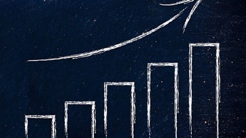 Drawing of graph with arrowing curving upward on dark background