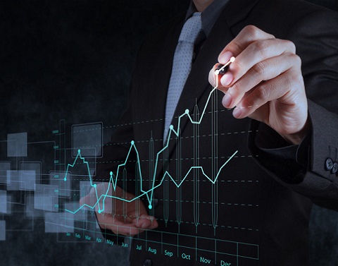A man in a suit drawing a digital graph on glass with the line increasing