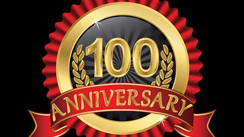 Gold and red circle with text celebrating an 100 year anniversary