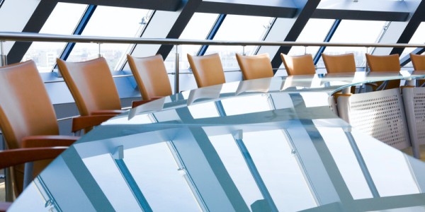 Boardroom table with empty chairs