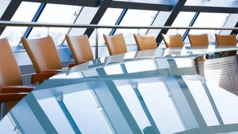 Boardroom table with empty chairs