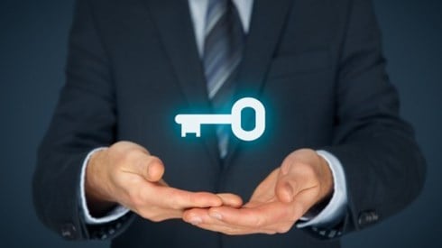 Businessman Holding Glowing Key