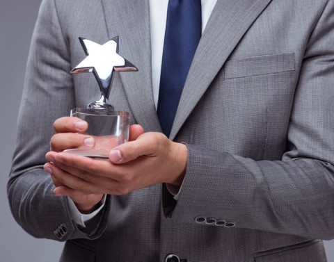 Businessman holding star trophy
