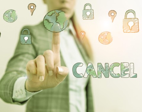 Businesswoman pointing to images of globes and location markers with the word cancel written on the right